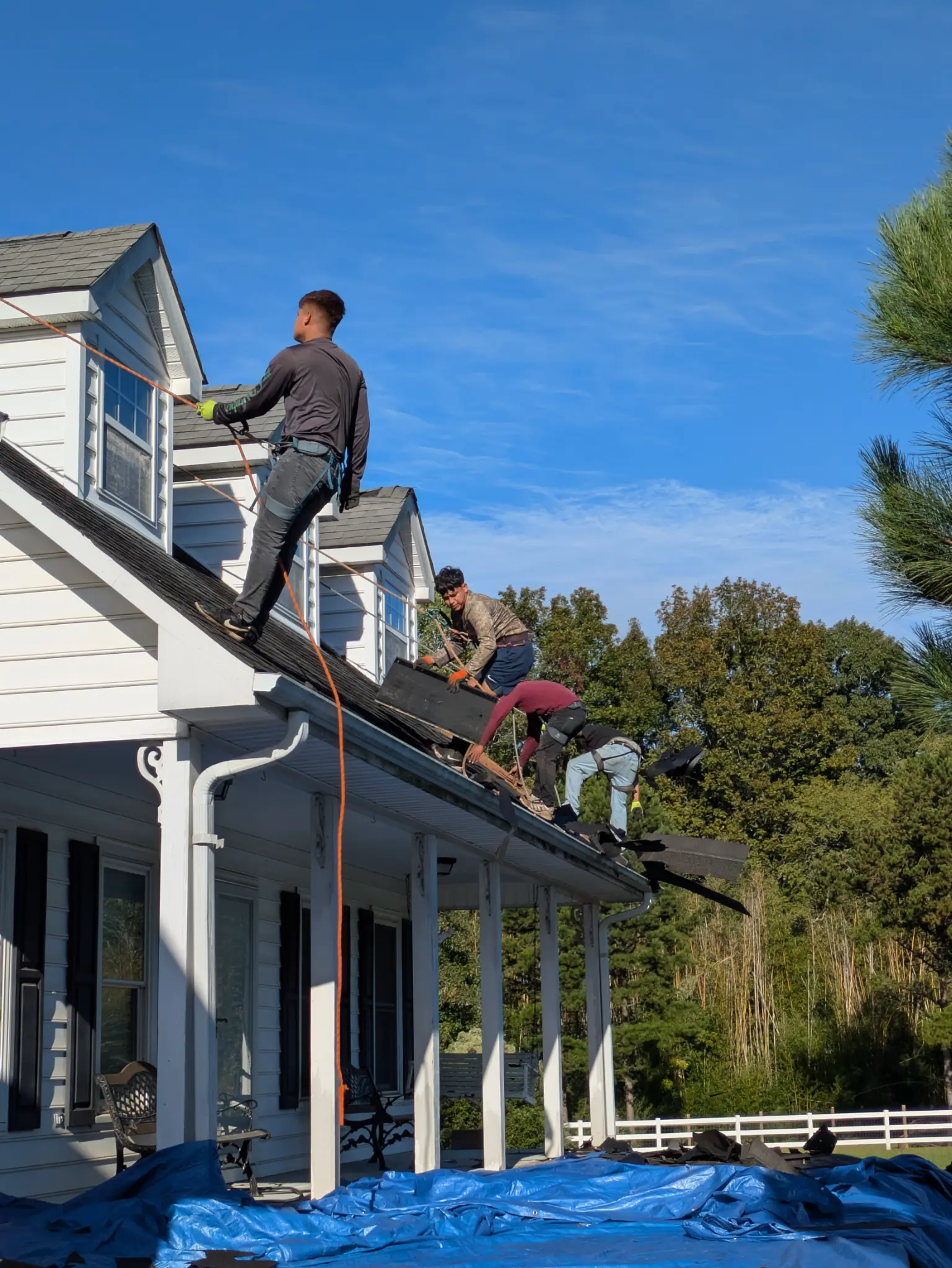 Happy Days Roofing crew installing shingles on a North Carolina home